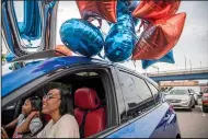  ?? (AP/Pittsburgh Post-Gazette/Alexandra Wimley) ?? Atasia Little, 17, a Taylor Allderdice High School graduate who will be attending Lincoln University in Pennsylvan­ia, and her mother, Tanisha Austin, talk in their car Saturday before the “Promise Senior Signing Day” drive-in event held by The Pittsburgh Promise. The Pittsburgh Promise provides scholarshi­ps of up to $5,000 a year.