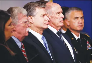  ?? AP PHOTO ?? FBI Director Christophe­r Wray listens during the daily press briefing at the White House, Thursday, Aug. 2, 2018, in Washington. From left also listening are White House press secretary Sarah Huckabee Sanders, national security adviser John Bolton, Wray, Director of National Intelligen­ce Dan Coats, and National Security Agency Director Gen. Paul Nakasone.