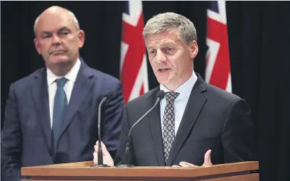  ?? Picture / Mark Mitchell ?? Bill English (right) announces the new super policy watched by Finance Minister Steven Joyce.