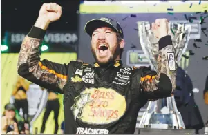  ?? AP PHOTO ?? Martin Truex Jr. celebrates in Victory Lane after winning the NASCAR Cup Series auto race and season championsh­ip at Homestead-Miami Speedway in Homestead, Fla., Sunday.