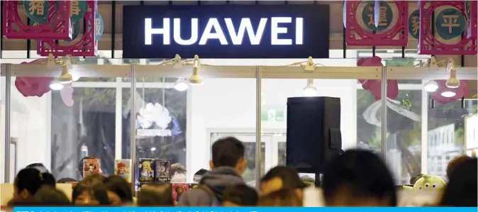  ??  ?? TAIPEI: People stand near a logo of Chinese telecoms giant Huawei at the Syntrend Creative Park in Taipei yesterday. —AFP