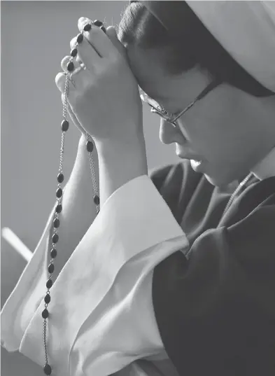  ?? PETER J. THOMPSON / NATIONAL POST ?? Sister Marita de la Fuente prays at the The Sisters of Life mission centre in Toronto. The Sisters of Life is a convent of young, ultra-conservati­ve Catholic nuns that was founded in New York in 1991, and arrived in Canada in 2007.