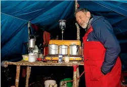  ?? ?? Ron Nilsson on one of his many expedition­s to record evidence of the existence of the South Island kō kako, and in his role as ‘‘camp dad’’. The bush was his happy place, his daughter says.