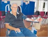  ??  ?? A regular donor, John Barrett relaxes while giving blood.