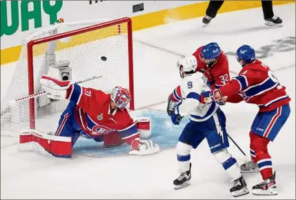  ?? Mark Blinch / Getty Images ?? Tyler Johnson of Tampa Bay scores against Montreal goalie Carey Price in the second period in Game 3 of the Stanley Cup Final at Bell Centre in Montreal. Johnson had two goals in the victory on Friday night.