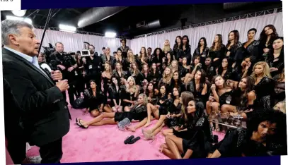  ??  ?? Glamour: Executive Ed Razek talks to models at one of the famed fashion shows