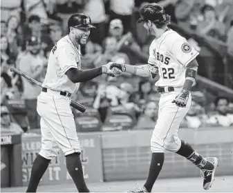  ?? Karen Warren / Staff photograph­er ?? The Astros’ Josh Reddick (22) celebrates his home run with George Springer during Saturday’s win over Arizona. The offense helped starter Charlie Morton win his 15th game.