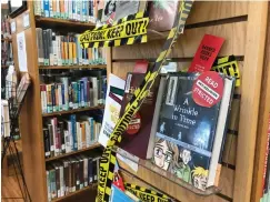  ?? Tribune News Service ?? ■ A display at the Guantanamo public library Sept. 27 not far from the thrift shop, gas station and McDonald's, sought to educate patrons about the American Library Associatio­n's annual Banned Books Week. This year's theme: "Banning Books Silences Stories." This photo was screened by a Navy base official, who approved its release to the public.