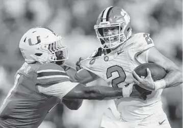  ?? RICH STORRY Rich Storry-usa TODAY Sports ?? Miami Hurricanes linebacker Corey Flagg Jr. (11) tackles Clemson Tigers quarterbac­k Cade Klubnik (2) to win the game in overtime Oct. 21, 2023, at Hard Rock Stadium at Miami Gardens, Fla.