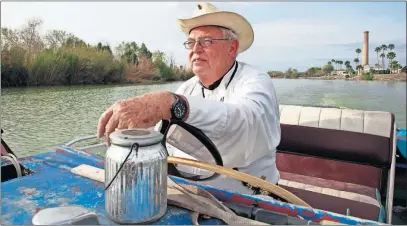  ?? [JOHN L. MONE/THE ASSOCIATED PRESS] ?? Father Roy Snipes sometimes takes his boat along the Rio Grande to his church, La Lomita Chapel. Part of the church land in Mission, Texas, could be seized by the federal government to construct additional border wall and fence lines.