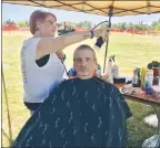  ??  ?? Stylist Anne Kelley gives Army veteran Michael Yandell a hair cut at the 20th annual Yuba-sutter Veterans Stand Down at Beckwourth Riverfront Park in Marysville on Thursday.