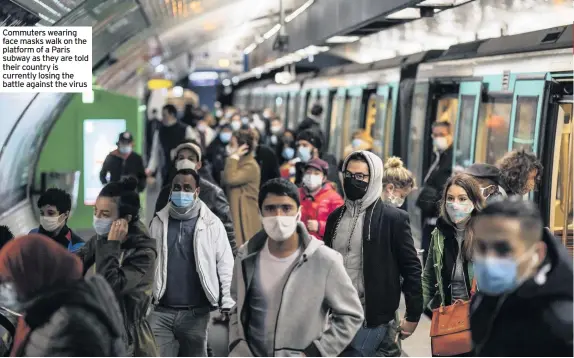  ??  ?? Commuters wearing face masks walk on the platform of a Paris subway as they are told their country is currently losing the battle against the virus