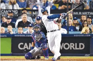  ?? AFP ?? YASIEL PUIG of the Los Angeles Dodgers hits a solo home run against Mike Montgomery of the Chicago Cubs during the seventh inning in Game One of the National League Championsh­ip Series at Dodger Stadium on Oct. 14 in Los Angeles, California.