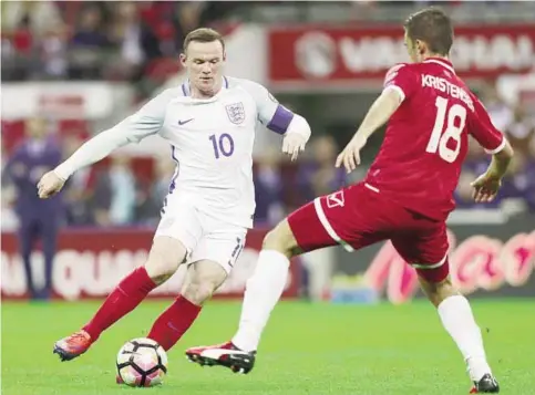  ?? —AFP ?? LONDON: England’s captain Wayne Rooney (L) vies with Malta’s midfielder Bjorn Kristensen during the World Cup 2018 football qualificat­ion match between England and Malta at Wembley Stadium.
