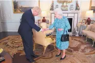  ?? VICTORIA JONES/ASSOCIATED PRESS ?? Britain’s Queen Elizabeth II welcomes newly elected leader of the Conservati­ve party Boris Johnson at an audience at Buckingham Palace on Wednesday.
