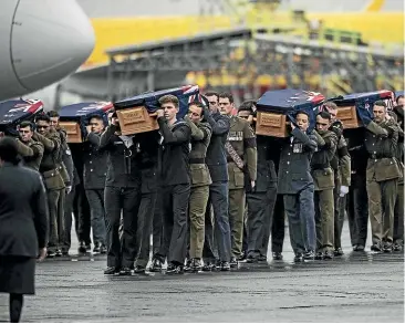  ?? LAWRENCE SMITH/ STUFF ?? The remains of 27 New Zealand servicemen and one child arrive back from Singapore to an official military welcome at Auckland airport.