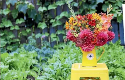  ?? LYNDA HALLINAN/STUFF ?? The simple act of bunging a few flowers – dahlias, achilleas, alstroemer­ias, heleniums and gladioli – into a jug brings endless summer joy.