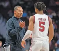  ?? AP PHOTO/SEAN RAYFORD ?? South Carolina head coach Lamont Paris talks with South Carolina guard Meechie Johnson (5) on Feb. 22 during the Gamecocks’ 78-76 loss to Alabama in Columbia, S.C.