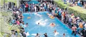  ?? ?? Demonstrat­ors inside Gotabaya Rajapaksa’s residence and (above) taking a dip in his pool