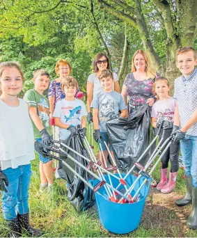  ??  ?? Back (from left ) is Margaret Heron, Christine Adam and Lianne, with some of the children during the clean-up.