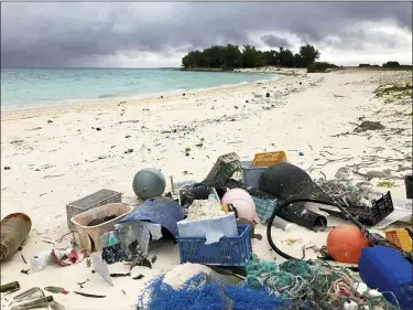 ?? CALEB JONES — THE ASSOCIATED PRESS ?? Plastic and other debris sits on the beach on Midway Atoll in the Northweste­rn Hawaiian Islands in October 2019. According to a study released on Friday, Oct. 30, more than a million tons a year of America’s plastic trash isn’t ending up where it should. The equivalent of as many as 1,300 plastic grocery bags per person is landing in places such as oceans and roadways.