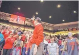  ?? ROBERTO E. ROSALES/JOURNAL ?? New Mexico men’s basketball coach Paul Weir, waving to the student section after the Jan. 27 home game against Colorado State, is working to bring Lobo fans back.