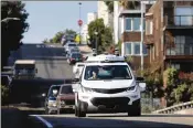  ?? JIM WILSON / THE NEW YORK TIMES ?? A GM autonomous car drives through San Francisco in November. SoftBank Vision Fund will invest in GM Cruise Holdings in two phases.