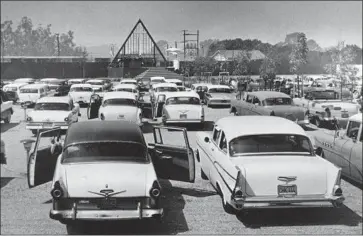  ?? Los Angeles Times ?? THE REV. Robert Schuller met his parishione­rs where they were — in their Chevys, Fords and Pontiacs.