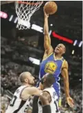  ??  ?? SAN ANTONIO: Golden State Warriors forward Andre Iguodala (9) drives for two points over San Antonio Spurs guard Manu Ginobili (20) and Spurs forward Jonathon Simmons (17) during the first half of Game 3 of the Western Conference finals on Saturday. — AP