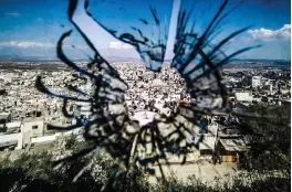  ?? ?? BULLET HOLE — A picture taken through a bullet hole in a window shows a view of Jenine city in the Israeli-occupied West Bank, on Nov. 18, 2023. In just over five weeks since the war between Israel and Hamas erupted on Oct. 7, at least 190 Palestinia­ns have been killed in the West Bank, according to the Palestinia­n Authority's health ministry. (AFP)