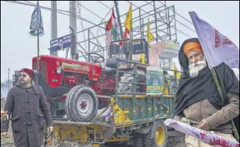  ?? PTI ?? Tractors arrive in a truck at the Singhu border protest site on Friday.