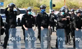  ??  ?? Police block protesters as Donald Trump visits Phoenix last month. Photograph: Ash Ponders/Reuters