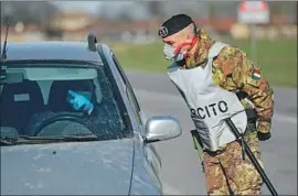  ??  ?? AN ITALIAN soldier talks with a driver at a checkpoint near the town of Castiglion­e d’Adda late last month amid fears over the spread of the novel coronaviru­s.