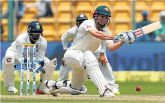  ??  ?? Australia’s Shaun Marsh plays a shot in his innings of 66. Reprieve: