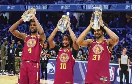  ?? CHARLES KRUPA / AP ?? The Cleveland Cavaliers’ Darius Garland (10) celebrates with teammates Evan Mobley (4) and Jarrett Allen as they hold up their trophies after winning the team shooting part during the skills challenge competitio­n Saturday in Cleveland.