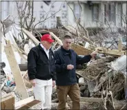  ?? ALEX BRANDON — THE ASSOCIATED PRESS ?? President Donald Trump speaks with Mike Herrick of the Putnam County Rescue Squad as he tours damage from a tornado Friday in Cookeville, Tenn.