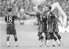  ??  ?? (LtoR) Bayern Munich’s Spanish defender Juan Bernat, Bayern Munich’s Dutch midfielder Arjen Robben, Bayern Munich’s Brazilian defender Rafinha, Bayern Munich’s Moroccan Mehdin Benatia and Bayern Munich’s Austrian defender David Alaba celebrate after...