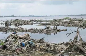  ?? — AFP ?? today, ebrie lagoon is a sick and sorry sight, choked by plastic pollution and ravaged by sand extraction and unbridled developmen­t.