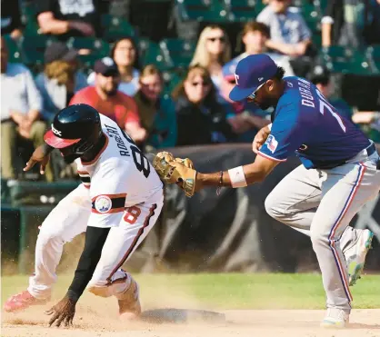  ?? QUINN HARRIS/GETTY ?? Ezequiel Duran of the Texas Rangers tags out Luis Rober for the final out to secure an 8-6 win in 12 innings on Sunday.