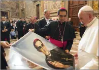  ?? L'OSSERVATOR­E ROMANO/POOL PHOTO VIA AP ?? In this October 2015 file photo, Pope Francis is presented with an image of Roman Catholic Archbishop Oscar Romero during a private audience granted to participan­ts to the pilgrimage from El Salvador at the Vatican. Pope Francis has cleared the way for...