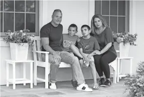  ?? TANIA SAVAYAN/USA TODAY NETWORK ?? Alex and Sarah Kooluris with sons AJ and Holden. AJ is autistic and nonverbal, and has regressed without in-person therapies.