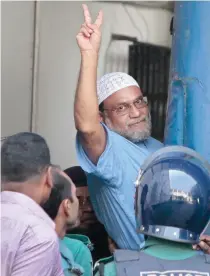  ??  ?? DEFIANT: Mir Quasem Ali, a senior leader of the Bangladesh's largest Islamist party Jamaat-e-Islami shows victory sign as he enters a police van after a special tribunal sentenced him to death in Dhaka on Sunday. (AP)