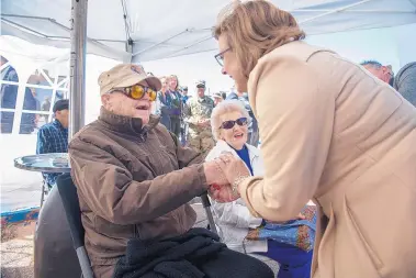  ?? EDDIE MOORE/JOURNAL ?? Bataan veteran Bill Overmier, left, and his wife, Ann, are greeted by Gov. Susana Martinez Monday during the annual Santa Fe commemorat­ion of the fall of the Philippine­s’ Bataan Peninsula and the subsequent Bataan Death March.