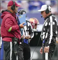  ?? (AP/Bryan Woolston) ?? Referee John Hussey reviews a play during an NFL game in October in East Rutherford, N.J. The Indianapol­is Colts are proposing a rule change that would allow for challenges of penalty calls in the last two minutes of the half.
