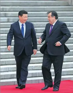  ?? WU ZHIYI / CHINA DAILY ?? President Xi Jinping greets his Tajikistan­i counterpar­t, Emomali Rahmon, at a welcoming ceremony on Thursday outside the Great Hall of the People in Beijing.