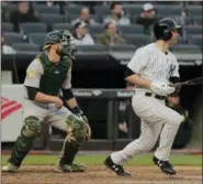  ?? JULIE JACOBSON — THE ASSOCIATED PRESS ?? Neil Walker, right, watches his game-winning hit to center field during Yankees’ victory over Athletics Saturday at Yankee Stadium.