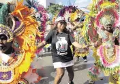  ?? ALIE SKOWRONSKI askowronsk­i@miamiheral­d.com ?? Valda McKinney, president of the A. Philip Randolph Institute Miami-Dade Chapter, dances with the Junkanoo band during a Souls to the Polls event outside of the Joseph Caleb Center on Sunday in Miami.