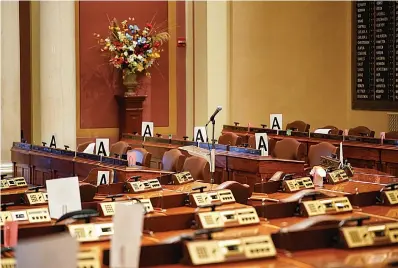  ?? Associated Press ?? ■ The House chamber at the state Capitol is empty March 18 in St. Paul, Minn., with some desks marked with an "A" — those desks may be occupied when lawmakers return to maintain "social distancing" because of the COVID-19 coronaviru­s.