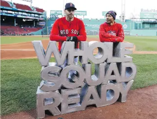  ?? ELISE AMENDOLA/THE ASSOCIATED PRESS ?? Boston Red Sox sluggers J.D. Martinez, left, and Mookie Betts are ready to go as the sign says for what promises to be a vintage World Series against the Los Angeles Dodgers.