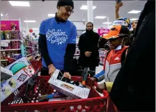  ?? PHOTOS BY KARL MONDON STAFF PHOTOGRAPH­ER ?? Golden State Warrior Jordan Poole joins a holiday shopping spree for families from the Oakland Boys & Girls Club at the Target store in Alameda on Friday.